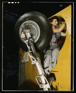 This woman is working inside a wheel well, at Vultee-Nashville. She is working on a "Vengeance" diver bomber. From the Library of Congress WWII Color Photograph collection.Photographer: Alfred T. Palmer